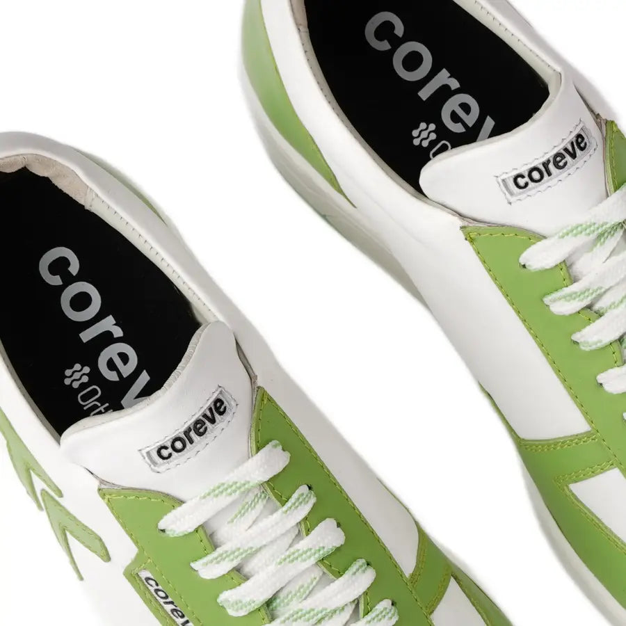Green sneakers with white laces and 'coreve' branding on a white background